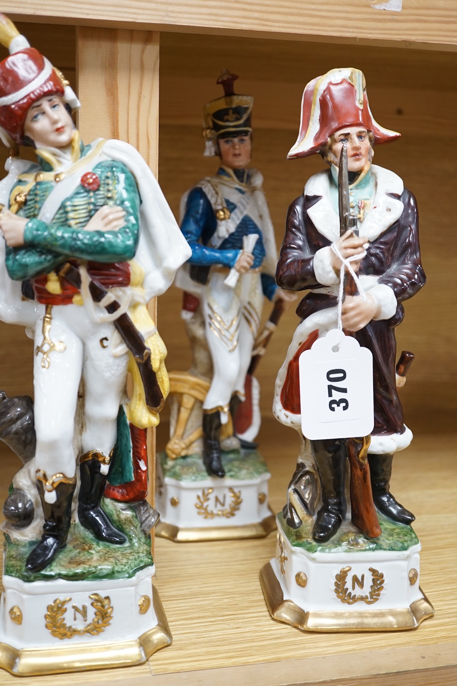 Six continental porcelain figures of soldiers, 32cm